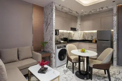 a living room with a couch and a table at Valia Hotel Bangkok in Bangkok