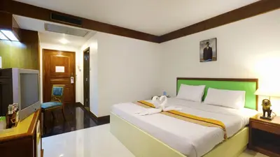 a bedroom with a bed with a white bow on it at Silom Avenue Inn in Bangkok