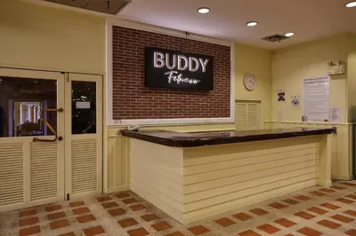 a restaurant with aubry kitchen sign on the wall at Buddy Lodge, Khaosan Road in Bangkok