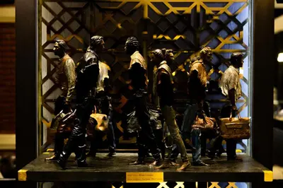 a group of figurines in a display case at Buddy Lodge, Khaosan Road in Bangkok