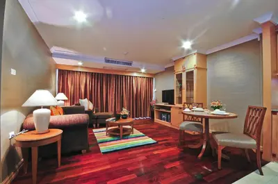 a living room with a couch and a table at Admiral Suites Bangkok in Bangkok
