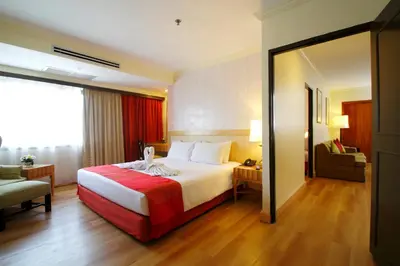 a hotel room with a bed and a chair at Princeton Bangkok in Bangkok