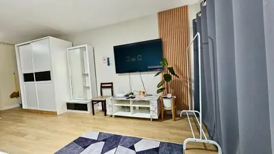 a room with a desk and a tv on the wall at อิมแพ็ค เมืองทองธานี ห้องเช่ารายวัน เมืองทอง popular condo C5 in Ban Bang Phang