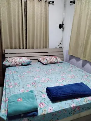 a bed with two pillows on top of it at Danee Hostel in Bangkok