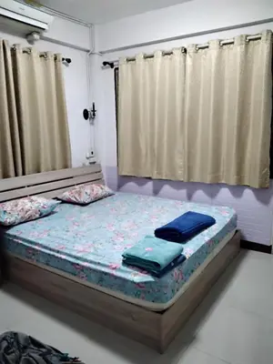 a bed with two pillows on it in a room at Danee Hostel in Bangkok