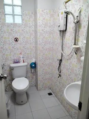 a bathroom with a toilet and a sink at Danee Hostel in Bangkok