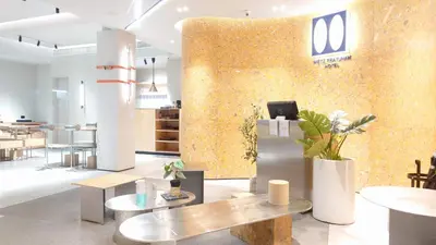 a lobby with a wall covered in gold paint at Metz Pratunam in Bangkok