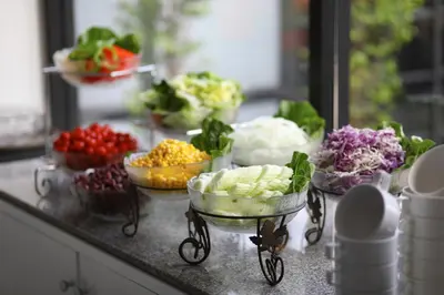 a buffet of vegetables in bowls on a counter at Anya Nana at Sukhumvit Bangkok in Bangkok