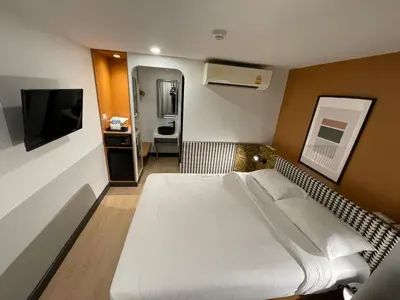 a hotel room with a bed and a television at Anya Nana at Sukhumvit Bangkok in Bangkok