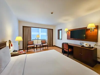 a hotel room with a bed and a desk at Ramada by Wyndham D MA Bangkok in Bangkok