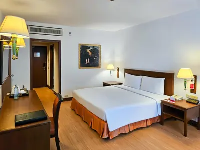 a hotel room with a large bed and a desk at Ramada by Wyndham D MA Bangkok in Bangkok
