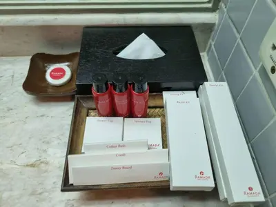 a table with red shoes and boxes on it at Ramada by Wyndham D MA Bangkok in Bangkok