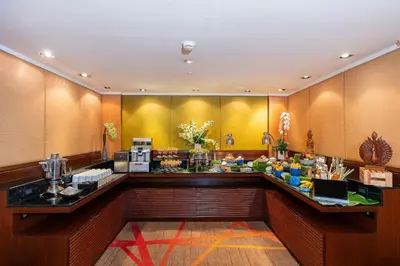 a lobby with a counter with food on it at Holiday Inn Bangkok Silom by IHG in Bangkok