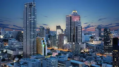 a city skyline at night with tall buildings at Holiday Inn Bangkok Silom by IHG in Bangkok