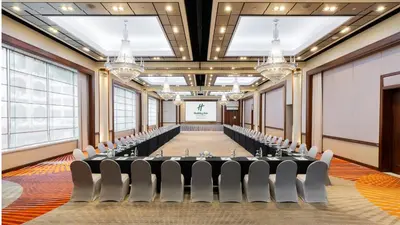 a conference room with a long table and chairs at Holiday Inn Bangkok Silom by IHG in Bangkok