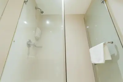 a shower in a bathroom with a glass shower stall at Seasons Siam Hotel in Bangkok
