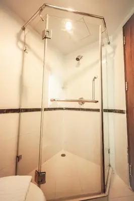 a shower with a glass door in a bathroom at The Seasons Bangkok Huamark in Bangkok