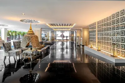 a lobby with couches and tables in a building at Night Hotel Bangkok - Sukhumvit 15 in Bangkok