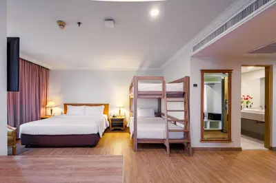 a bedroom with a bunk bed and a ladder at Prince Palace Hotel Bangkok in Bangkok