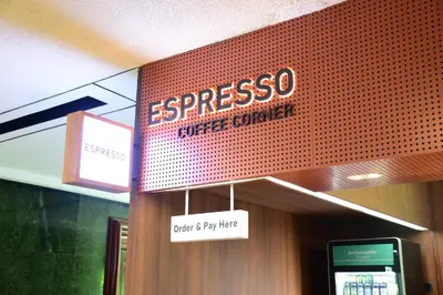 a sign for a coffee center in a building at Ambassador Hotel Bangkok in Bangkok