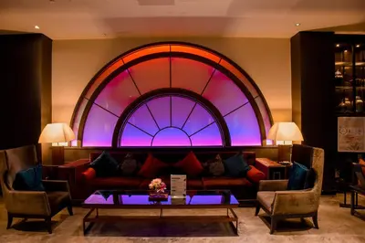 a living room with a couch and a stained glass window at Shanghai Mansion Bangkok in Bangkok