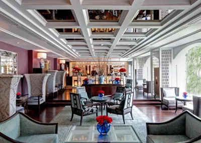 a lobby with a table and chairs and a bar at The Sukosol Hotel in Bangkok