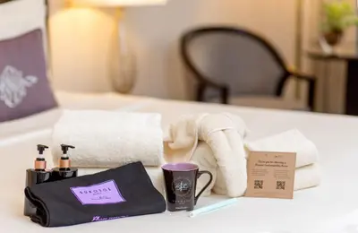 a table with towels and a bag and a cup at The Sukosol Hotel in Bangkok