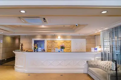 a bar in a lobby with a couch in front of it at Forum Park Hotel in Bangkok