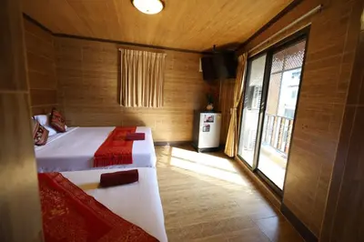 a small room with a bed and a window at Thai Cozy House in Bangkok