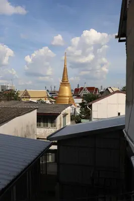 a view of a gold pagoda in a city at Thai Cozy House in Bangkok