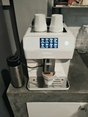 a coffee maker with a cup on a counter at The Chatbox Silom Hostel in Bangkok