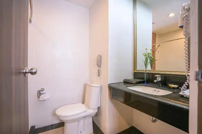 a bathroom with a toilet and a sink at FuramaXclusive Sukhumvit in Bangkok