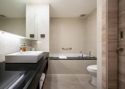 a bathroom with a sink and a toilet at Adelphi Suites Bangkok in Bangkok