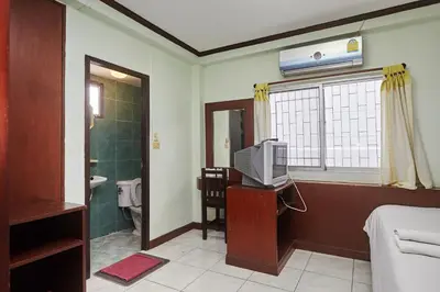 a room with a television and a bathroom at Amarin Inn in Bangkok