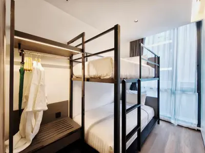 two bunk beds in a room with a window at Citichic Sukhumvit 13 by Compass Hospitality - Newly Renovated in Bangkok