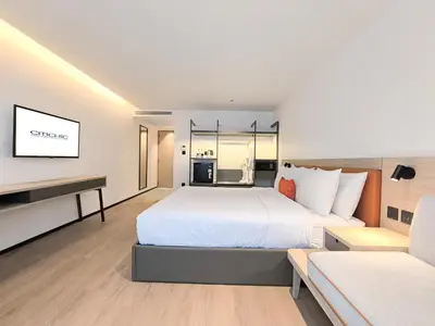 a bedroom with a large bed and a tv at Citichic Sukhumvit 13 by Compass Hospitality - Newly Renovated in Bangkok