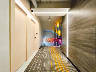 a hallway with a yellow stripe on the floor at Citichic Sukhumvit 13 by Compass Hospitality - Newly Renovated in Bangkok