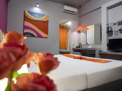 a bedroom with a bed and a painting on the wall at Baiyoke Boutique Hotel in Bangkok