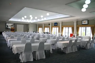 a large banquet hall with white tables and chairs at Baiyoke Boutique Hotel in Bangkok