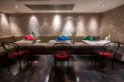 a dining room with a long table and chairs at Tai Pan Hotel in Bangkok