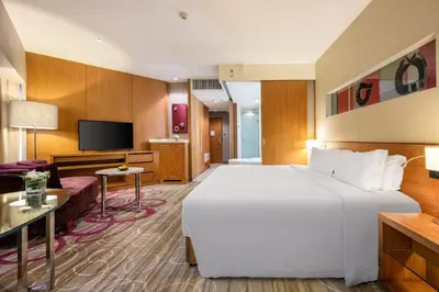 a hotel room with a large bed and a tv at Centara Grand at Central Plaza Ladprao Bangkok in Bangkok