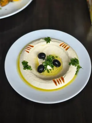 a plate of food with a dessert in the shape of a face at Boss Suites Nana Hotel in Bangkok