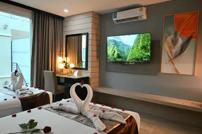 a hotel room with two swans on two beds at Boss Suites Nana Hotel in Bangkok