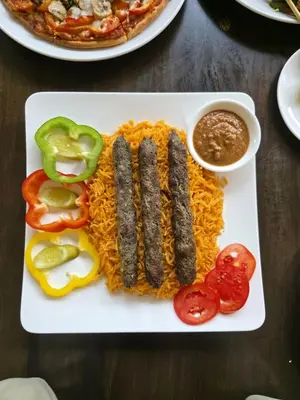 a plate of food with sausages and rice at Boss Suites Nana Hotel in Bangkok
