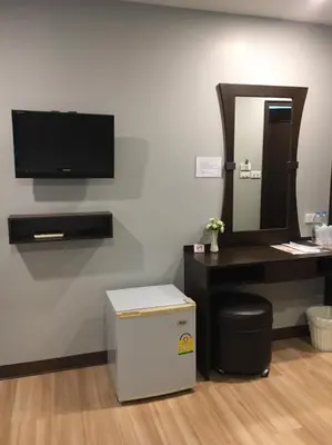a room with a desk with a tv and a mirror at YWCA Hotel Bangkok in Bangkok