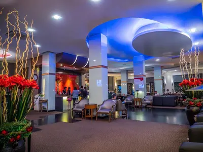 a lobby with chairs and people in a building at Atrium Boutique Hotel in Bangkok