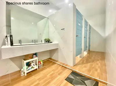 a bathroom with a sink and a mirror at Click Hostel in Bangkok