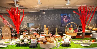 a buffet of food on a table in a restaurant at Le Fenix Sukhumvit 11 Bangkok in Bangkok