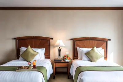 a hotel room with two beds and a tray with toys at Baiyoke Sky Hotel in Bangkok