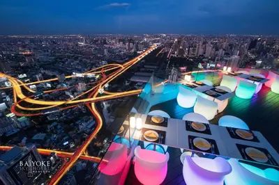 an aerial view of a city at night at Baiyoke Sky Hotel in Bangkok